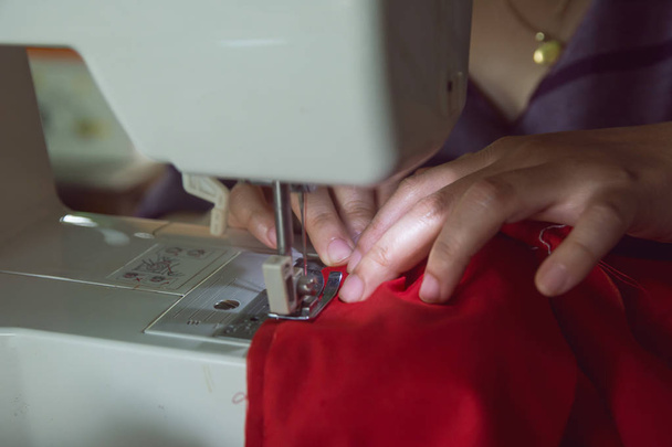 Woman seamstress working making clothes on a sewing machine.  - Photo, Image