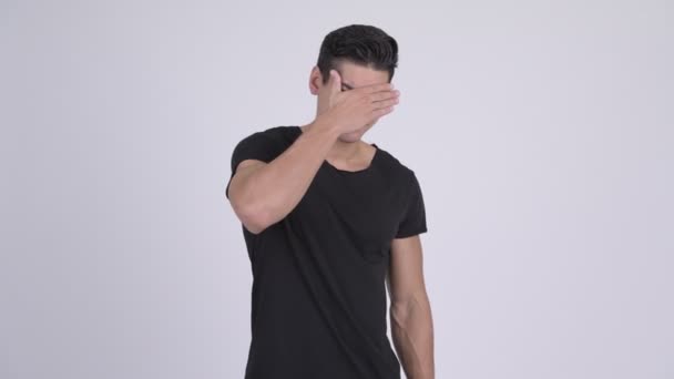 Young stressed multi-ethnic man covering eyes - Footage, Video