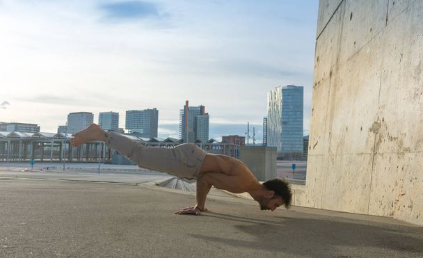 Man performing advanced yoga exercises and stretching to keep the body healthy - Фото, зображення