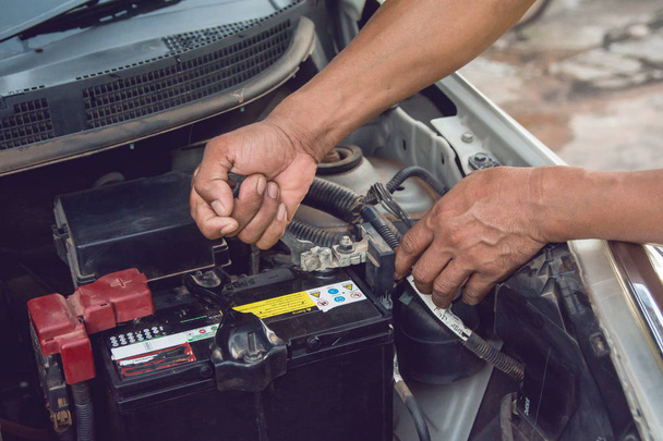 Car mechanic working Install battery with wrench in garage. Repair service. - Φωτογραφία, εικόνα