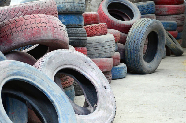 A picture of many old used tires left on a waste dump. The picture of an ecological problem and disaster - Photo, Image