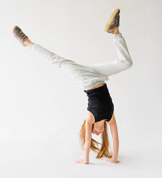 Little girl do a handstand - Foto, immagini