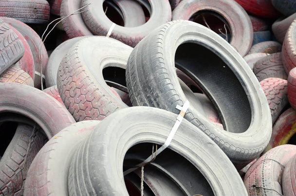 Una foto de muchos neumáticos usados viejos dejados en un vertedero. La imagen de un problema ecológico y un desastre
 - Foto, imagen