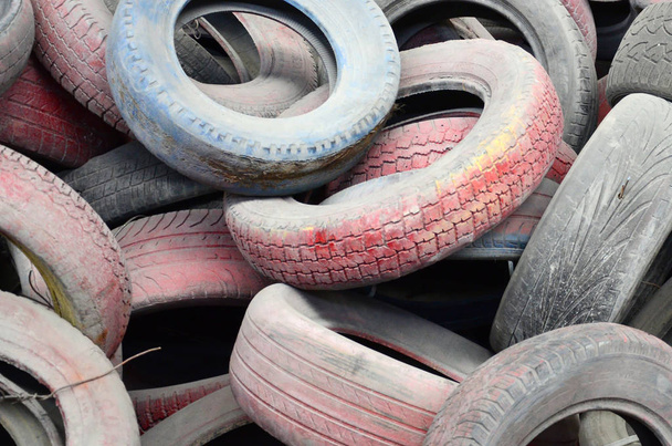 A picture of many old used tires left on a waste dump. The picture of an ecological problem and disaster - Photo, Image