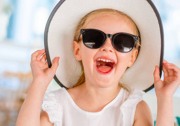 Little laughing blond girl in black sunglasses - Foto, Imagem