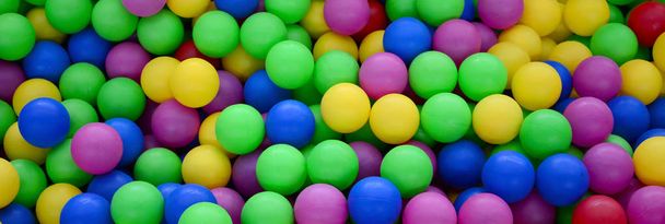Colored plastic balls in pool of game room. Swimming pool for fun and jumping in colored plastic balls - Photo, Image