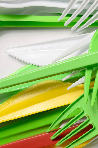 Pile of bright yellow, green and white used plastic kitchenware appliances. Ecological problem. Plastic pollution - Photo, Image