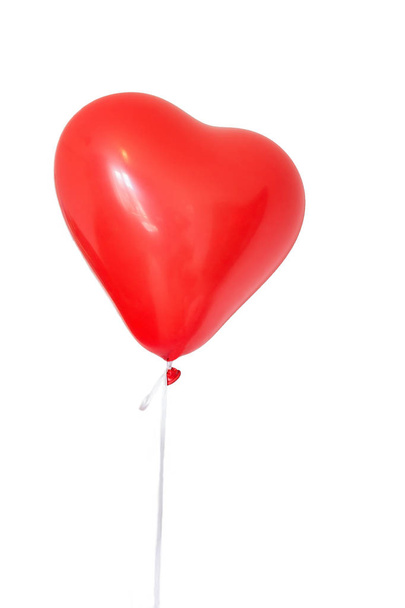 one heart shaped red balloon on white background - Фото, зображення