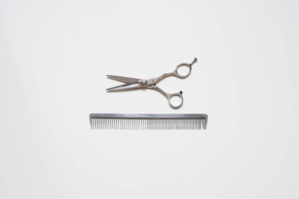 flat lay hairdressing scissors and a comb isolated on white background - Photo, Image