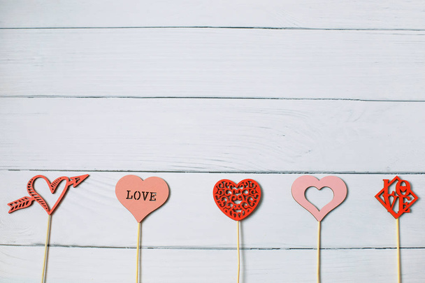 Coloridos corazones de madera en línea como regalo para el Día de San Valentín. El corazón es amor de caída. Marco de trabajo
 - Foto, Imagen