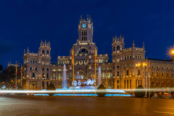 Madrid - Plaza de Cibeles with fountain and figure of Goddess Cibele and their lion driven cart, behind Palacio de Cibeles, post office and seat of the administration - Photo, Image