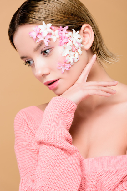beautiful girl with flowers on face isolated on beige - 写真・画像