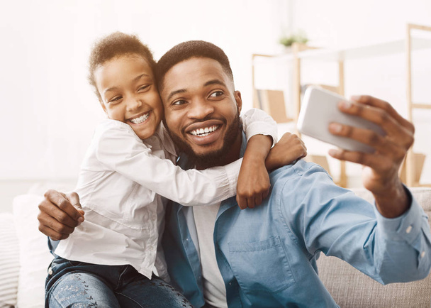 Father taking selfie with cute daughter at home - Photo, Image