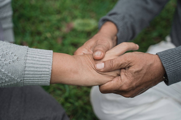 senior  hand massaging on someones palm - Photo, Image