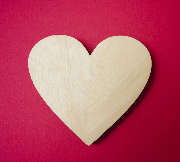 one wooden heart on on red background. i - Zdjęcie, obraz