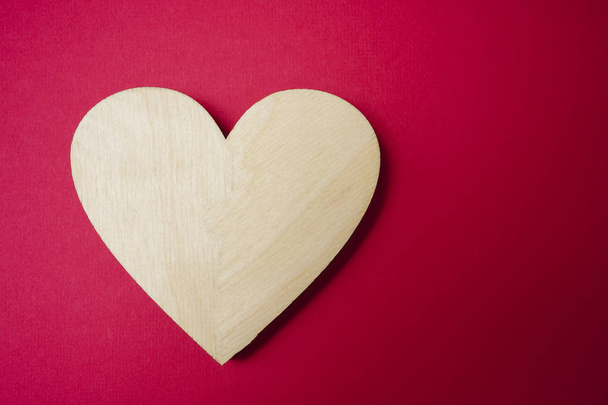 one wooden heart on on red background. i - Φωτογραφία, εικόνα