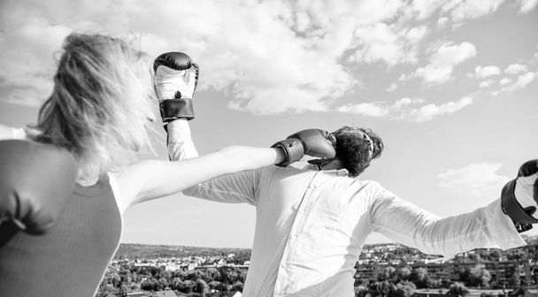Let her win concept. Couple boxing gloves fight sky background. Leadership family relations. Things guy can do to make woman happy. How to win her back effective tips. Girl confident strength power - 写真・画像