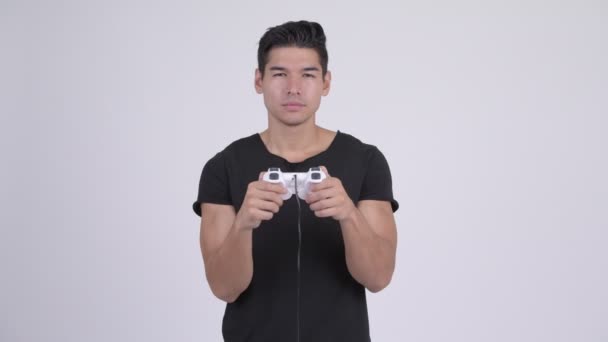 Young tired multi-ethnic man playing games and falling asleep - Footage, Video