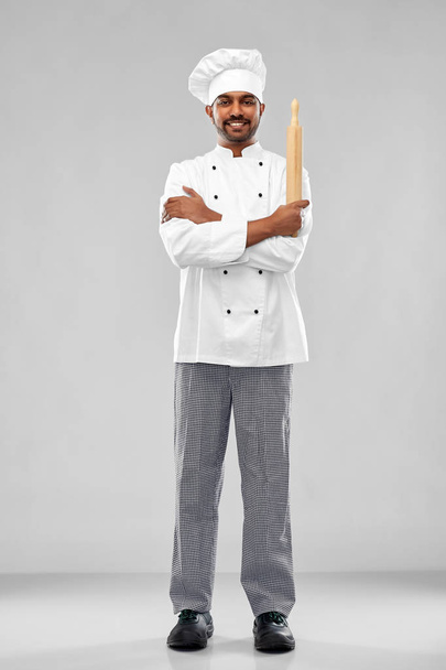 happy male indian chef or baker with rolling-pin - Zdjęcie, obraz