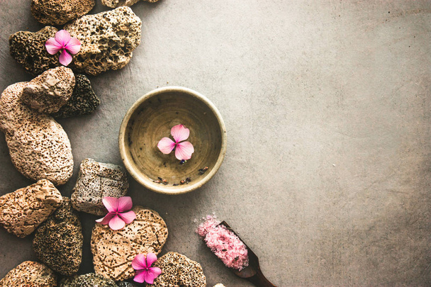 Spa product - facial tonic. Bath salt. Dayspa background with flowers and marine stones.  Spa and wellness setting. - 写真・画像