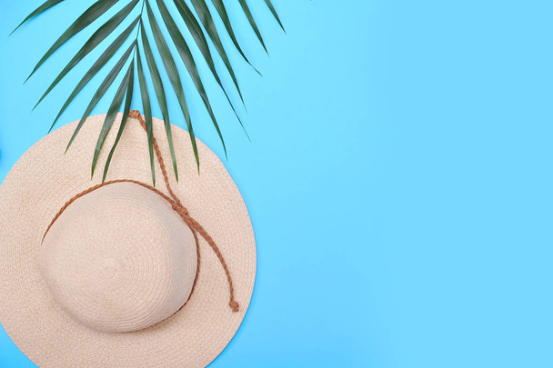 Palm leaf, pineapple and hat. Summertime background. Vacation concept. - 写真・画像