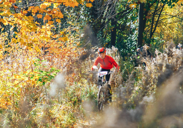 October 14, 2018 - Minsk, Belarus: 2018 Olympic Cross Country Cup XCO in Medvezhino, teenager boy riding bicycle on forest trail during race - Photo, Image