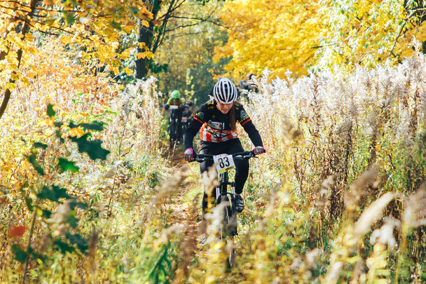 October 14, 2018 - Minsk, Belarus: 2018 Olympic Cross Country Cup XCO in Medvezhino, teenager boy riding bicycle on forest trail during race - 写真・画像