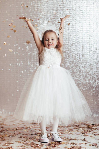little child girl in princess dress on confetti background - Photo, Image