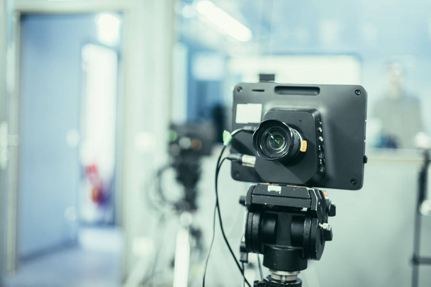 Lens of a film camera in an television broadcasting studio, spotlights and equipment - Photo, Image
