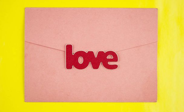 Valentines day greeting card with love word over wooden background. With space for your greetings - Photo, image
