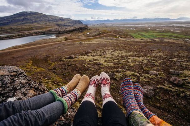 Legs in socks with beautiful ornament , on the Iceland nature and moss - Photo, Image