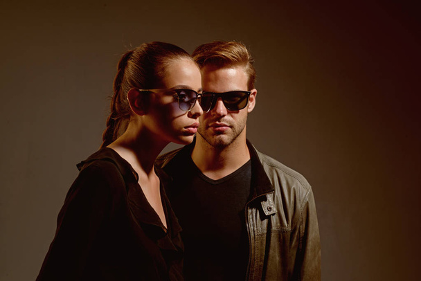 An intellectual look. Fashion models in trendy sun glasses. Couple in love. Couple of man and woman wear fashion glasses. Love relations. Friendship day. Friendship relations. Two hearts full of love - Фото, зображення