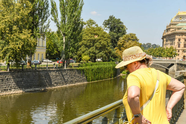 Praga, Republika Czeska - Spetember 2018: turysta patrząc w dół na część rzeki Wełtawy w Pradze. - Zdjęcie, obraz