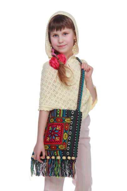 Pretty little girl with a bag of handmade on white background - Photo, Image