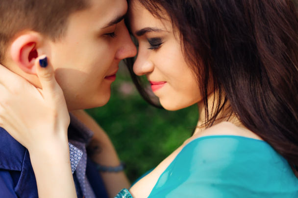 a close-up of a guy and girl who lean  their heads and closed their eyes - Photo, Image