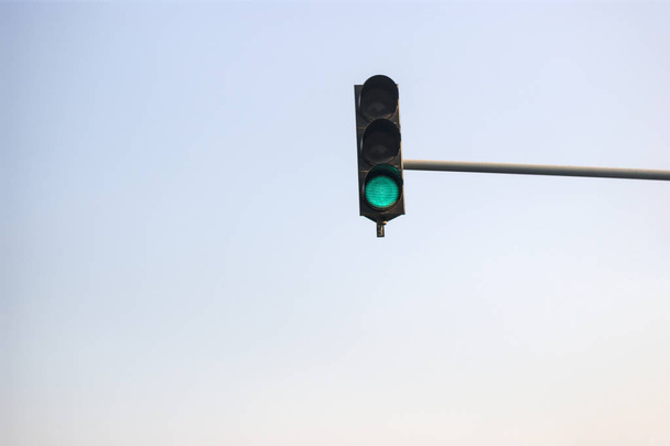 Traffic light on a blue sky. Green light is on. - Φωτογραφία, εικόνα