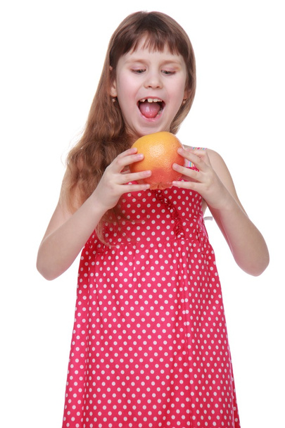 Cheerful girl holding grapefruit on white background - Foto, afbeelding