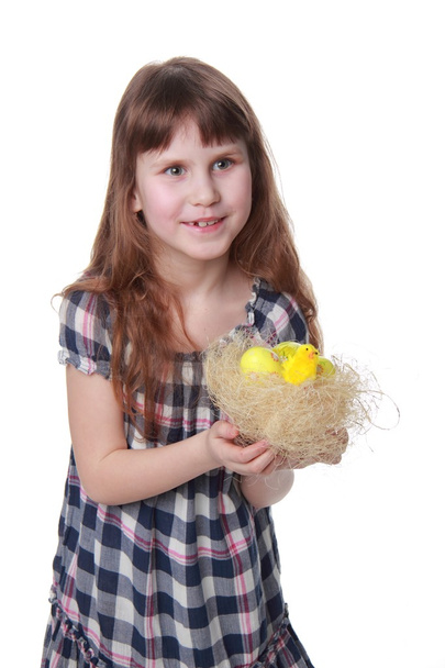 Happy little girl holding a decorative basket with Easter baby chicken - Photo, Image