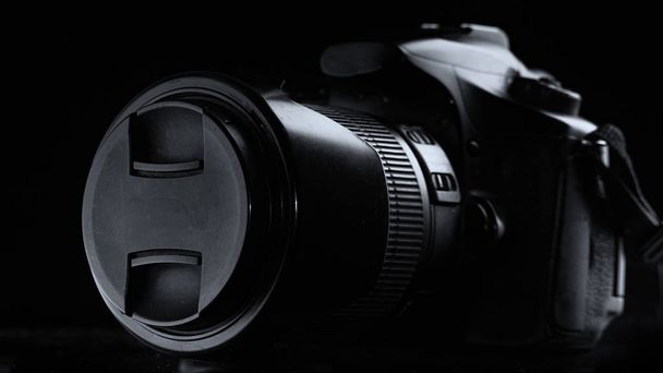 professional digital photo camera against black background close up - Photo, Image