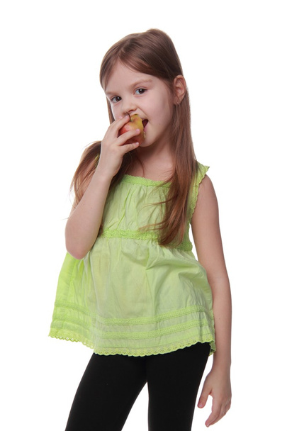 Happy cheerful girl eating an apple - Foto, afbeelding