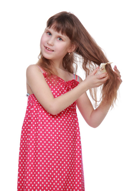 Cheerful little girl holding a seashell - Valokuva, kuva