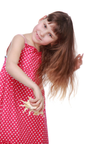 Cheerful little girl holding a seashell - Foto, immagini