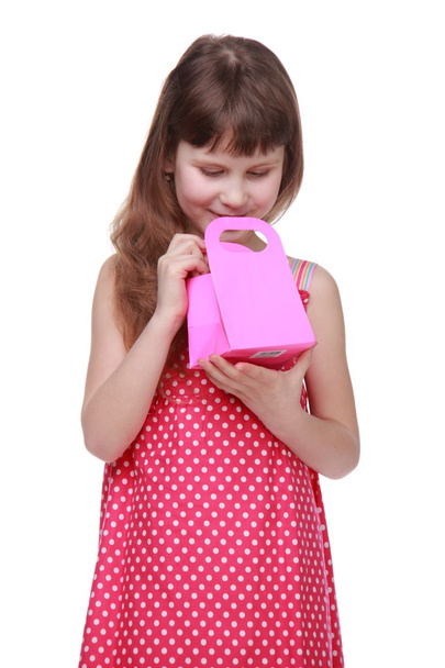 Healthy little girl in a summer dress holding a gift - Фото, изображение