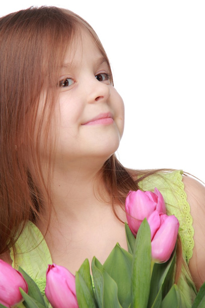 Happy little girl with a bouquet of tulips - Photo, Image