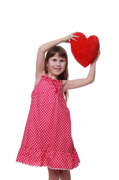 Cute little girl holding a toy heart - Fotó, kép
