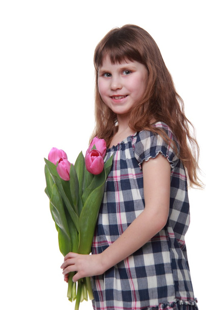 Portrait of a little girl with a big bouquet of tulips - Zdjęcie, obraz