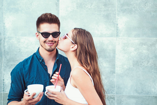 Enjoying the best coffee date. Couple of woman and man with coffee cups. Girlfriend and boyfriend have espresso or latter drink. Couple in love drink coffee outdoor. Going for coffee together - Zdjęcie, obraz