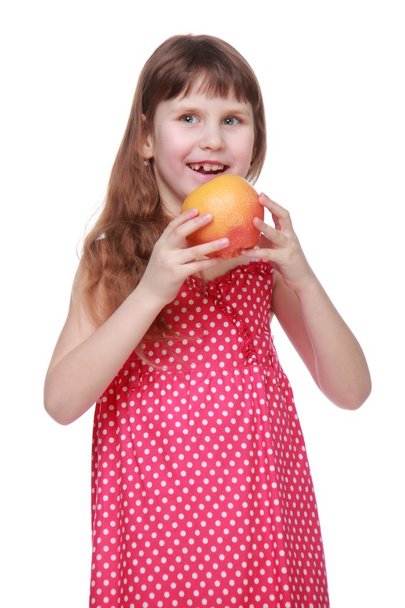 Charming child eating grapefruit - Photo, Image
