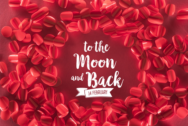round frame and beautiful decorative red petals with "to the moon and back, 14 february" lettering, valentines day background - Photo, Image