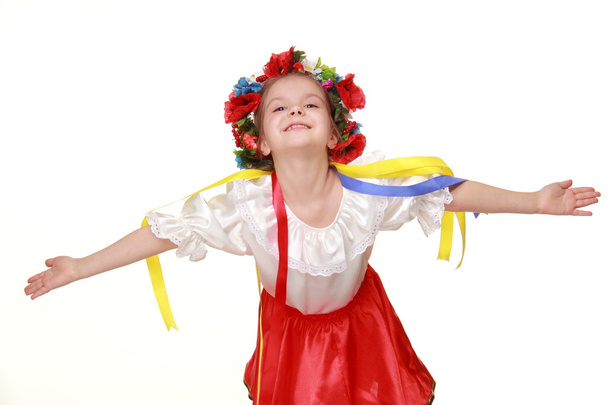 Little girl in Ukrainian national costume dances - Фото, зображення